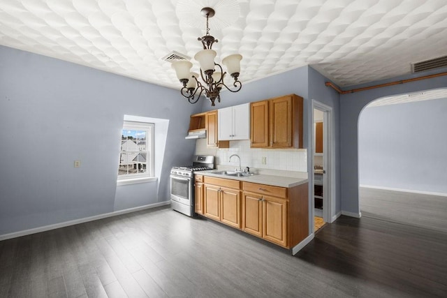 186 John St, Fall River, MA 02721 - kitchen with gas stove, a sink, a chandelier, light countertops, and baseboards
