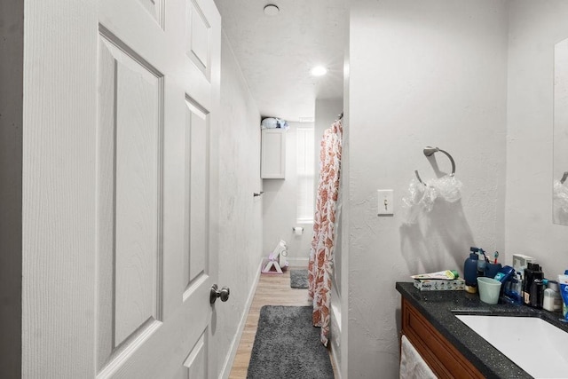 186 John St, Fall River, MA 02721 - full bath with wood finished floors, vanity, and a shower with shower curtain