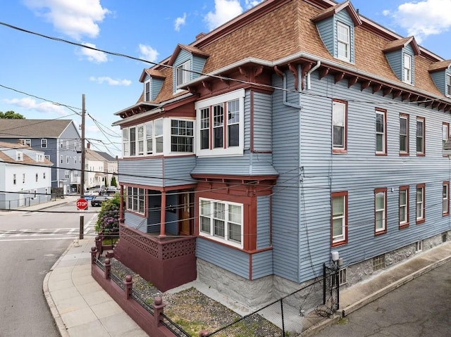 186 John St, Fall River, MA 02721 - view of side of home featuring a shingled roof and mansard roof