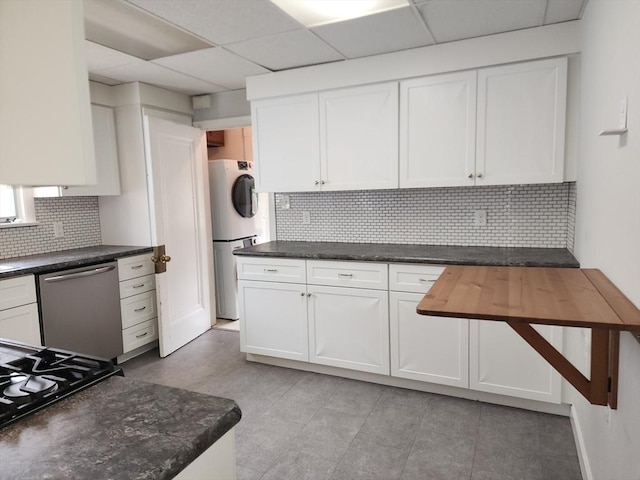 235 Common St, Watertown, MA 02472 - kitchen with stainless steel dishwasher, white cabinetry, backsplash, a drop ceiling, and cooktop