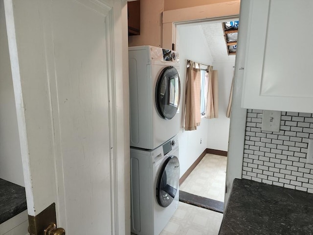 235 Common St, Watertown, MA 02472 - washroom with light flooring, stacked washer / drying machine, and baseboards