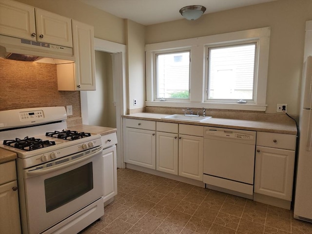 235 Common St, Watertown, MA 02472 - kitchen featuring white appliances, a sink, under cabinet range hood, white cabinets, and light countertops
