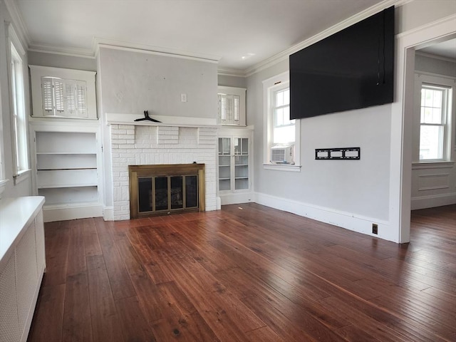 235 Common St, Watertown, MA 02472 - unfurnished living room featuring wood-type flooring, radiator heating unit, a fireplace, crown molding, and cooling unit