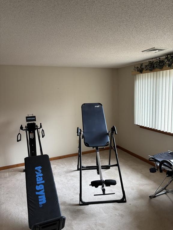 workout room with a textured ceiling