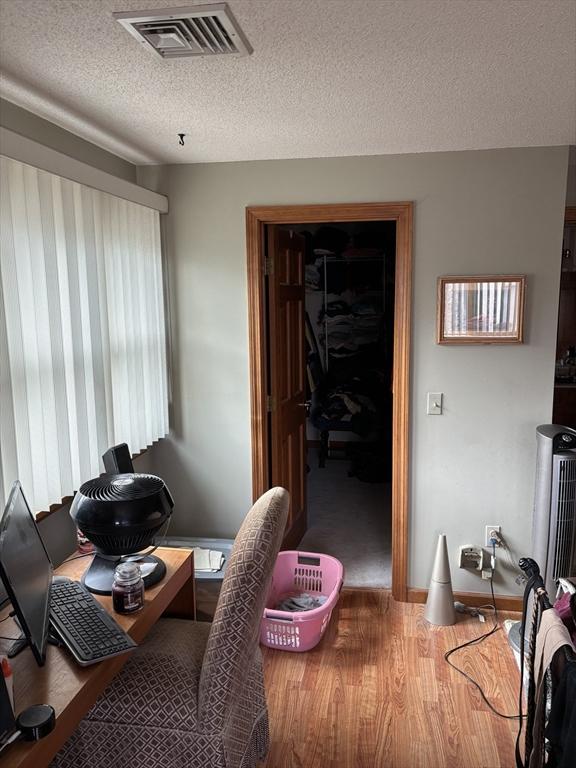 office featuring hardwood / wood-style flooring and a textured ceiling