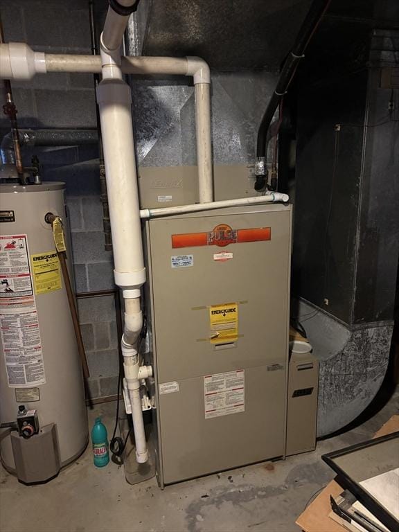 utility room featuring water heater