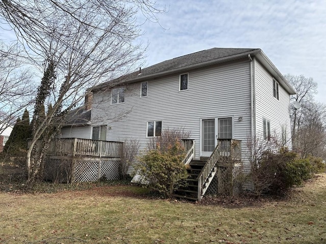 back of house featuring a deck and a yard