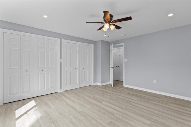 404 Broadway Unit 107, Lynn, MA 01904 - unfurnished bedroom featuring two closets, light wood finished floors, recessed lighting, and a ceiling fan