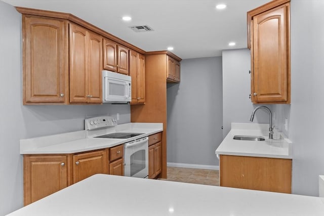 404 Broadway Unit 107, Lynn, MA 01904 - kitchen featuring white appliances, light countertops, recessed lighting, and brown cabinets