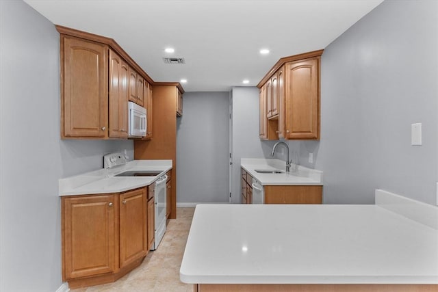 404 Broadway Unit 107, Lynn, MA 01904 - kitchen with white appliances, light countertops, recessed lighting, and brown cabinets