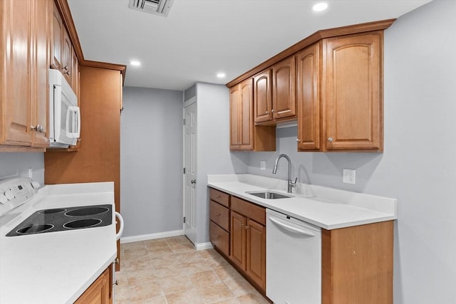 404 Broadway Unit 107, Lynn, MA 01904 - kitchen with white appliances, recessed lighting, light countertops, and brown cabinetry