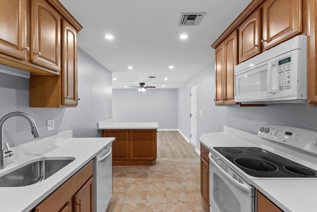 404 Broadway Unit 107, Lynn, MA 01904 - kitchen with white appliances, a ceiling fan, brown cabinetry, light countertops, and recessed lighting