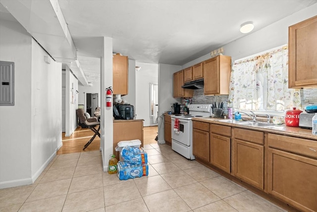 kitchen featuring sink, white electric range oven, backsplash, and light tile patterned floors