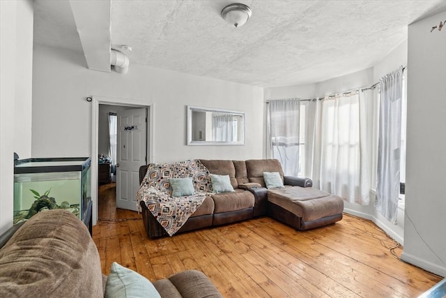 living room with hardwood / wood-style flooring and a textured ceiling