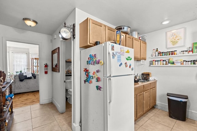 kitchen with white refrigerator and light tile patterned floors