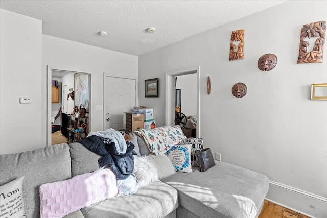 bedroom with hardwood / wood-style flooring and a textured ceiling