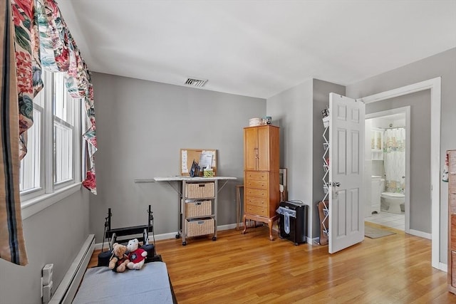 interior space with a baseboard radiator and light wood-type flooring