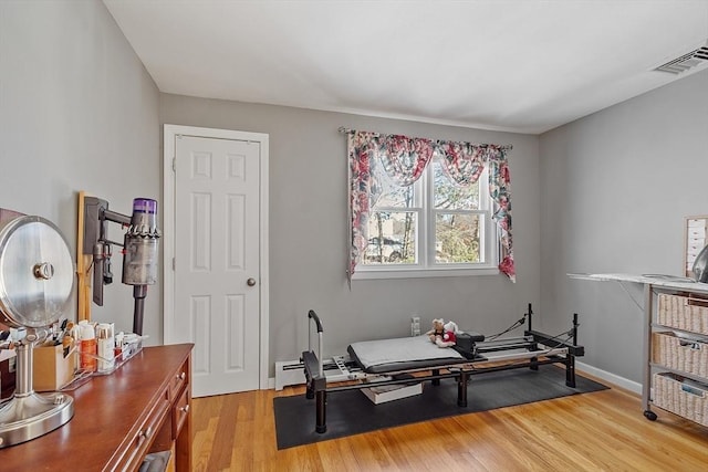 exercise room featuring light hardwood / wood-style floors