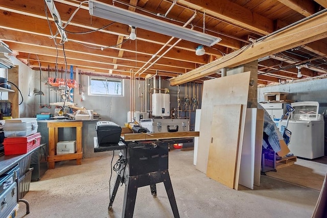 basement featuring water heater and washer / dryer