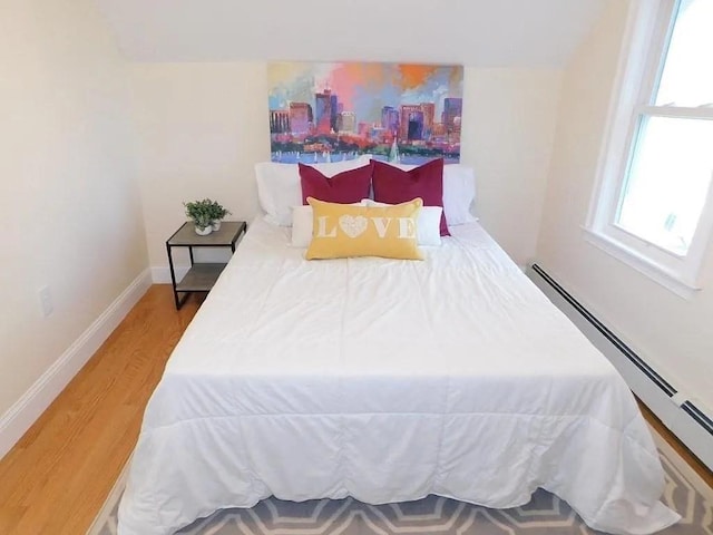 15 Phillips St, Weymouth, MA 02188 - bedroom with a baseboard heating unit, wood finished floors, and baseboards