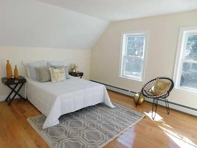 15 Phillips St, Weymouth, MA 02188 - bedroom featuring wood finished floors, vaulted ceiling, and a baseboard heating unit
