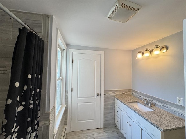 15 Phillips St, Weymouth, MA 02188 - full bathroom featuring tile walls, vanity, a shower with curtain, a baseboard heating unit, and wainscoting