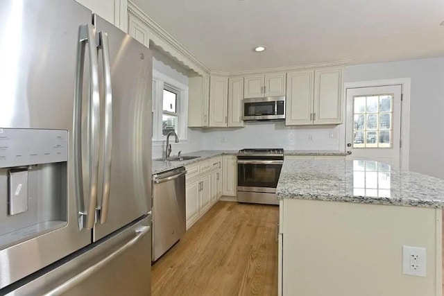 15 Phillips St, Weymouth, MA 02188 - kitchen with stainless steel appliances, a sink, light wood-style floors, healthy amount of natural light, and recessed lighting