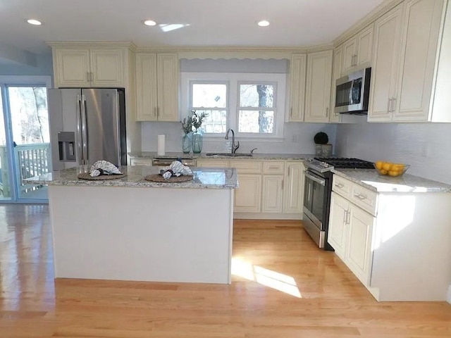 15 Phillips St, Weymouth, MA 02188 - kitchen featuring stainless steel appliances, a sink, light wood-style flooring, light stone countertops, and recessed lighting
