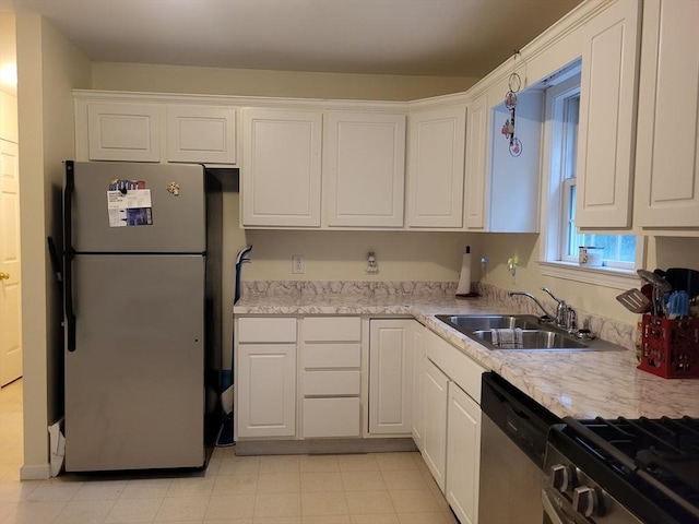 14 Robey St Unit 14, Boston, MA 02119 - kitchen with freestanding refrigerator, a sink, and white cabinets