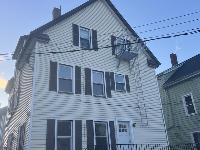 view of side of property featuring a chimney