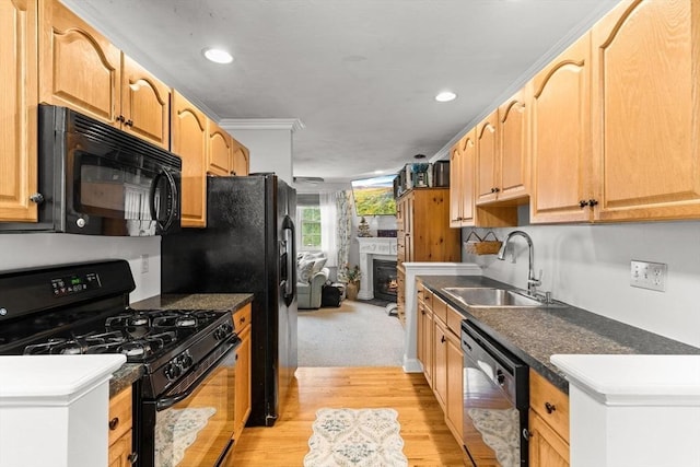 55 Williams St Unit 501, Taunton, MA 02780 - kitchen featuring black appliances, recessed lighting, light wood finished floors, dark countertops, and a lit fireplace
