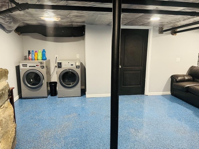 laundry room featuring laundry area, baseboards, and separate washer and dryer