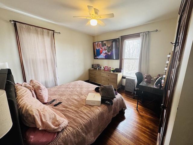 bedroom featuring radiator, ceiling fan, and wood finished floors