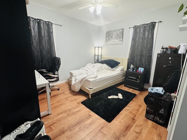 bedroom with a ceiling fan and wood finished floors