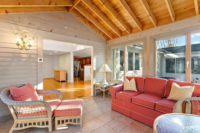 sunroom / solarium featuring vaulted ceiling with beams, a notable chandelier, and wood ceiling