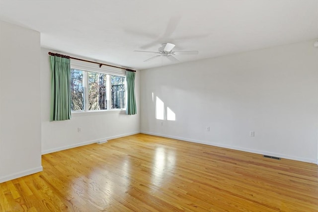 empty room featuring light wood-type flooring and ceiling fan