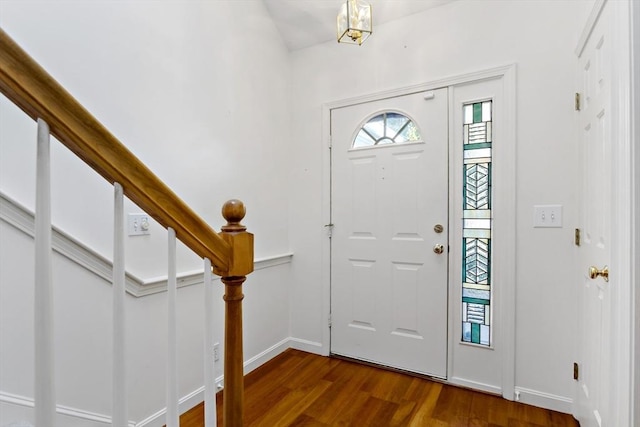 entryway featuring dark hardwood / wood-style floors and an inviting chandelier