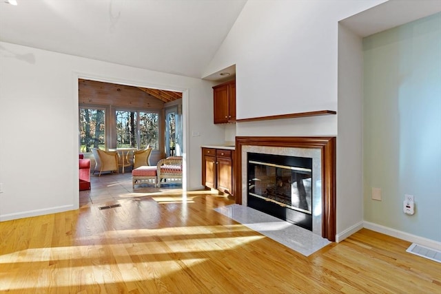 living room featuring light hardwood / wood-style flooring and lofted ceiling