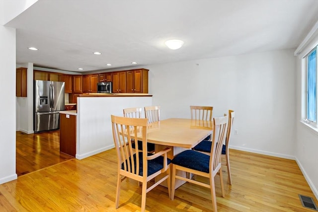 dining area with light wood-type flooring