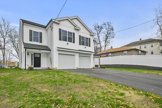 view of front of house featuring a garage and a front lawn