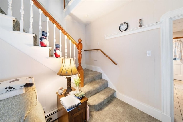 staircase featuring tile patterned flooring and baseboard heating