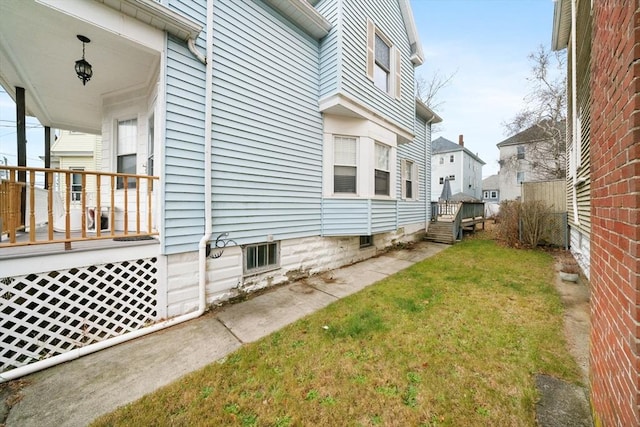 view of side of home featuring a lawn