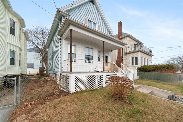 view of front of home featuring covered porch and a front yard