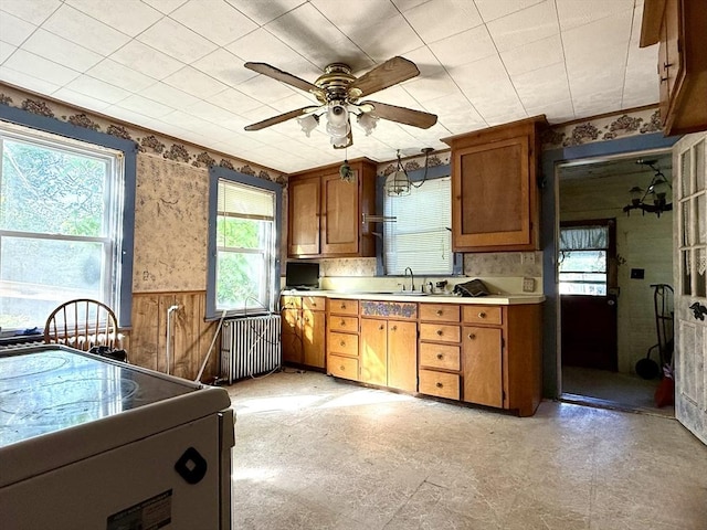 527 Collins Corner Rd, Dartmouth, MA 02747 - kitchen with radiator heating unit, plenty of natural light, light countertops, light floors, and a wainscoted wall
