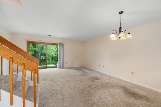 19 Garden St Unit 107, Danvers, MA 01923 - spare room featuring light colored carpet, a chandelier, and stairs