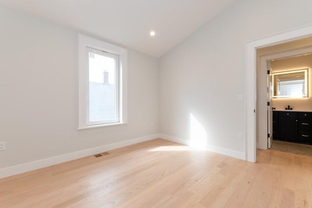 unfurnished room with light wood-style flooring, lofted ceiling, baseboards, and recessed lighting