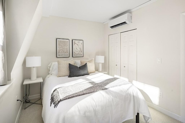 bedroom featuring light carpet, a closet, and an AC wall unit