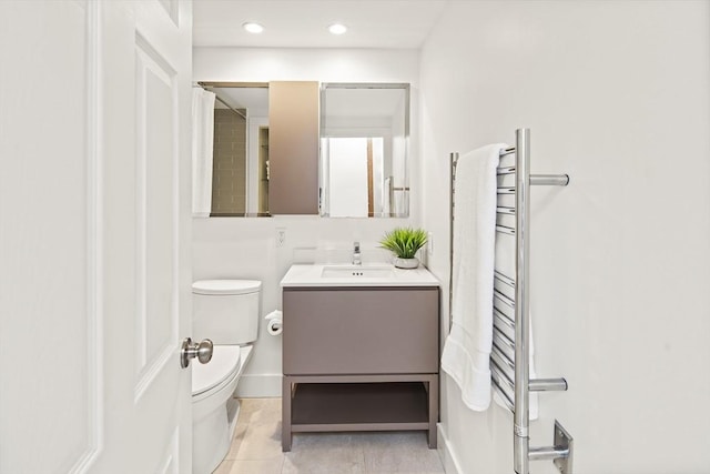 bathroom featuring toilet, vanity, and tile patterned flooring