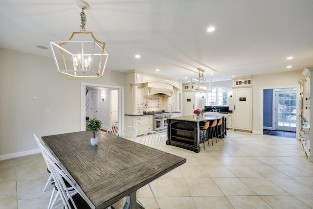 tiled dining space featuring a notable chandelier