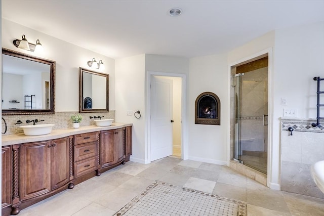 bathroom with tile patterned flooring, vanity, and a shower with shower door